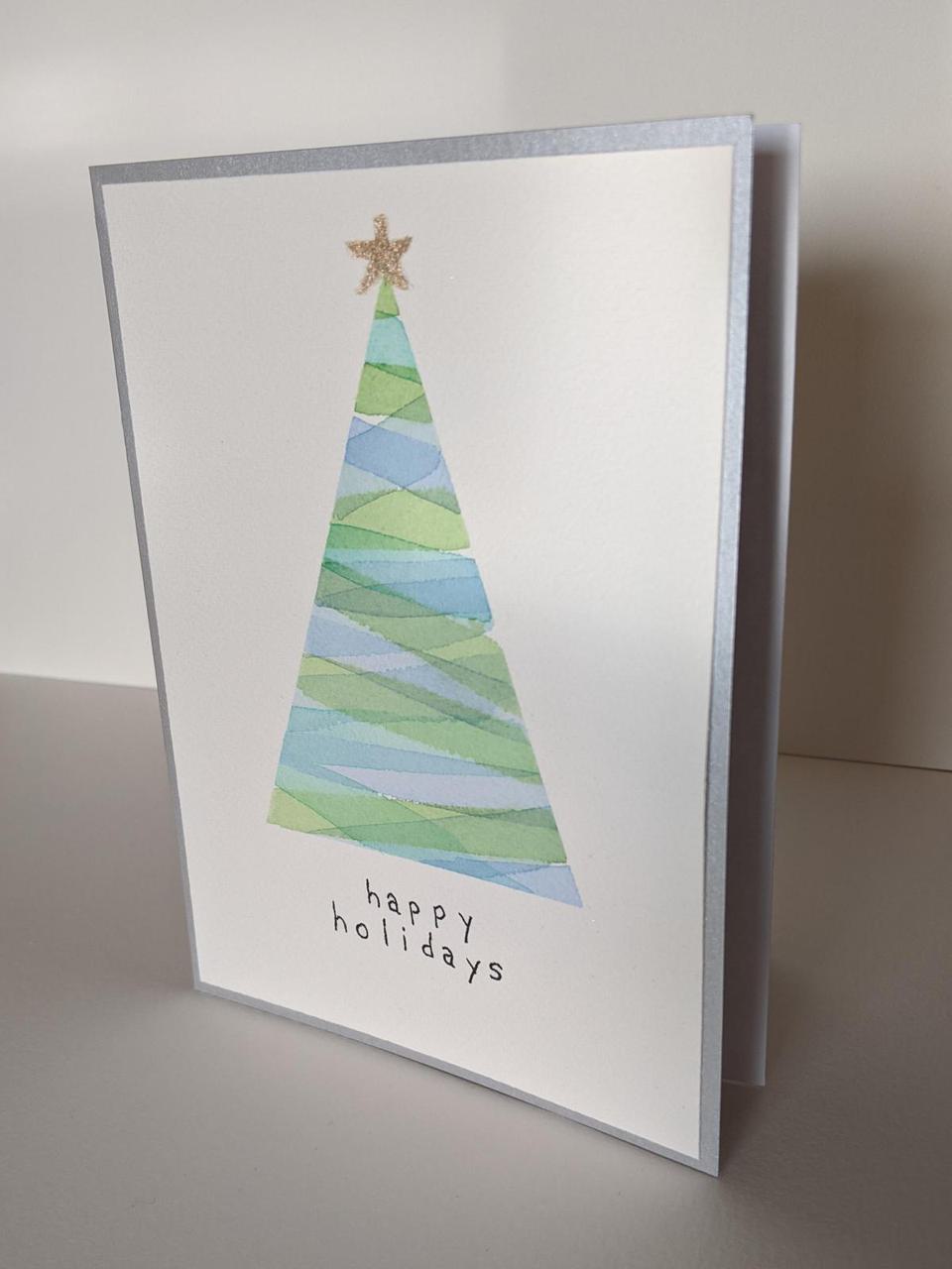 single triangle painted with stripes with a christmas star on the top.