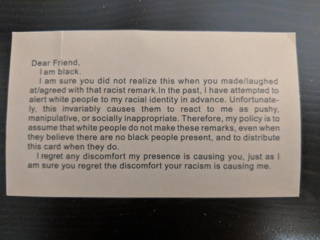 business card that starts with the words, "Dear friend, I am black." It continues by calling people out on their racism.