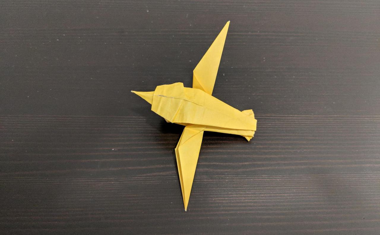 bird made out of paper, with wide wings and a round body.
