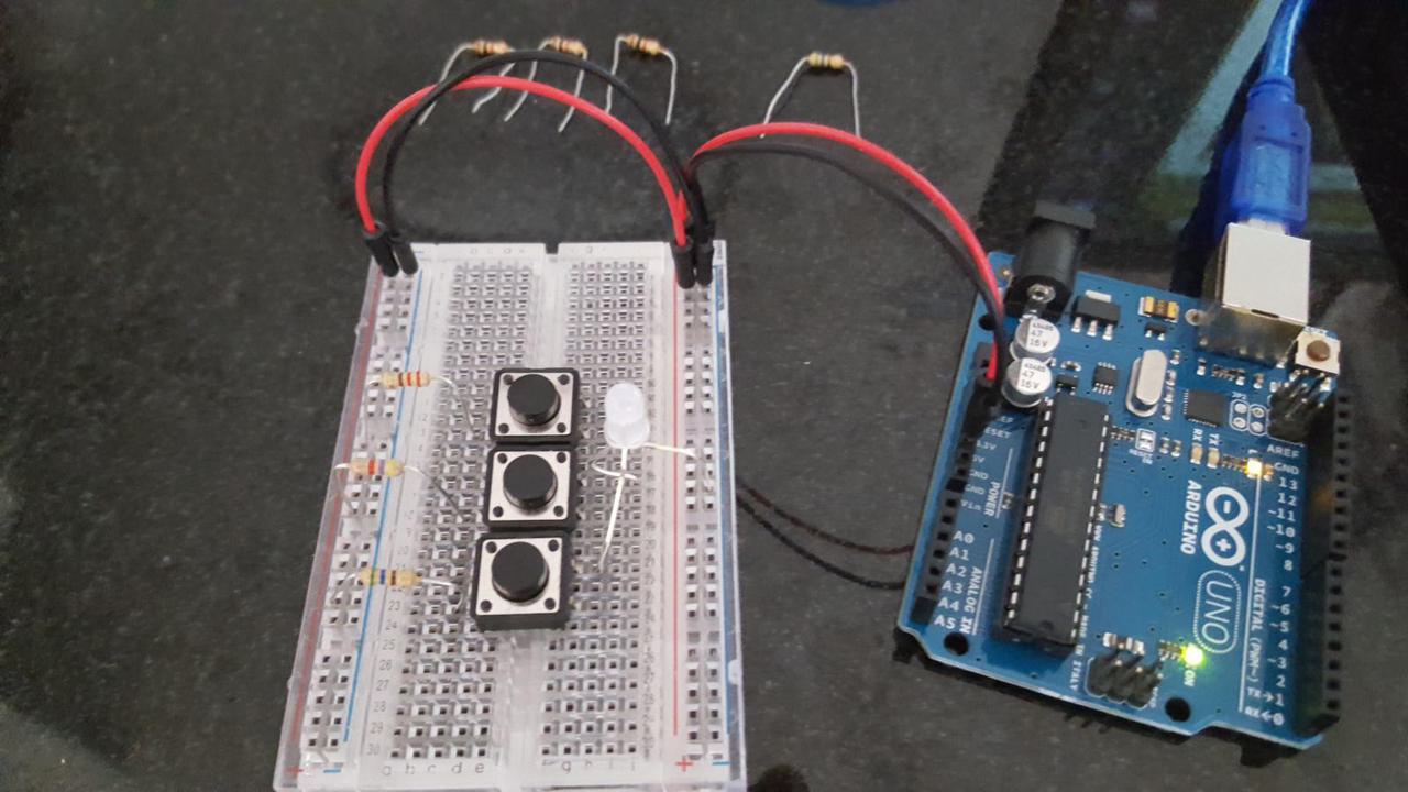 Arduino, breadboard with 3 buttons and 3 different resistors, all connected to a 3 color LED.
