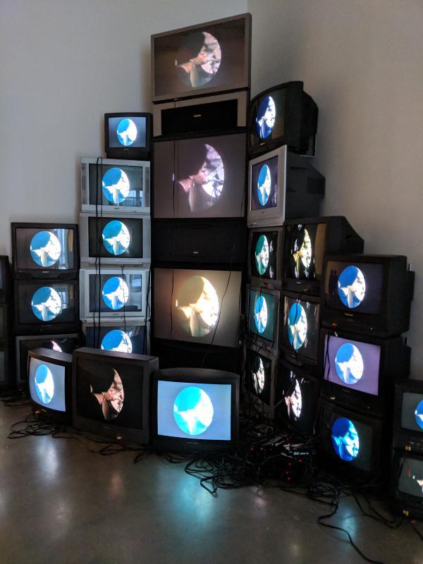 stack of TVs all showing the same image of Nina Simone singing