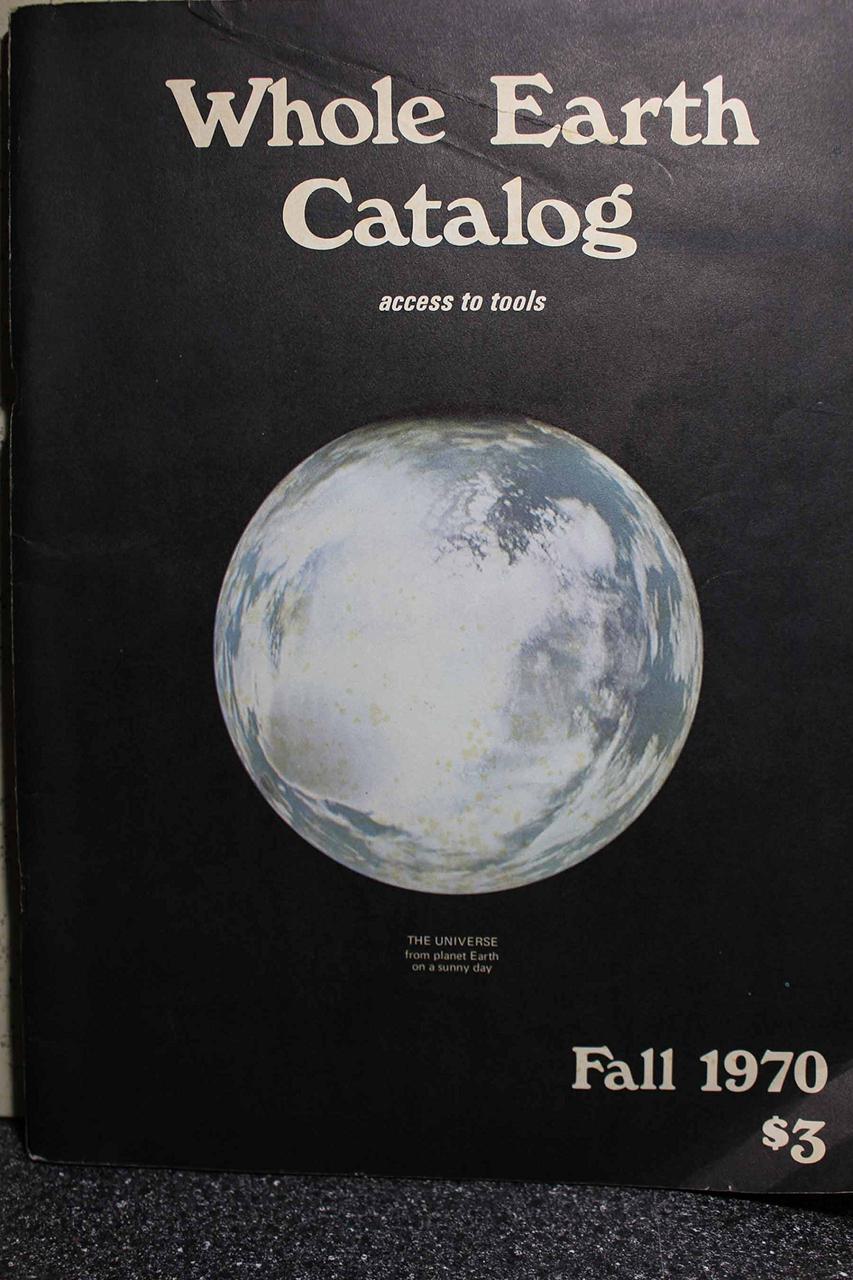 planet earth with black background and Whole Earth Catalog printed at the top.