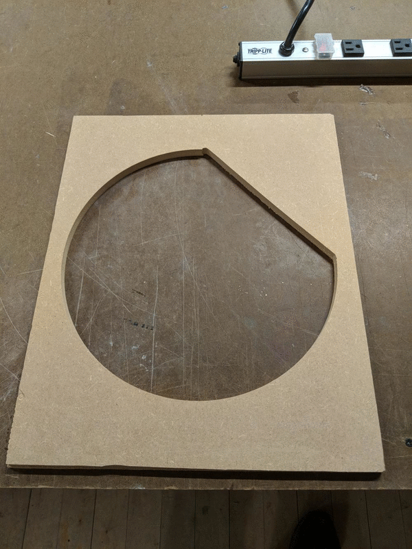 Animation showing two images of a circular shape cut out of a piece of wood and the original piece of wood with a the same shaped hole cut out of the center.