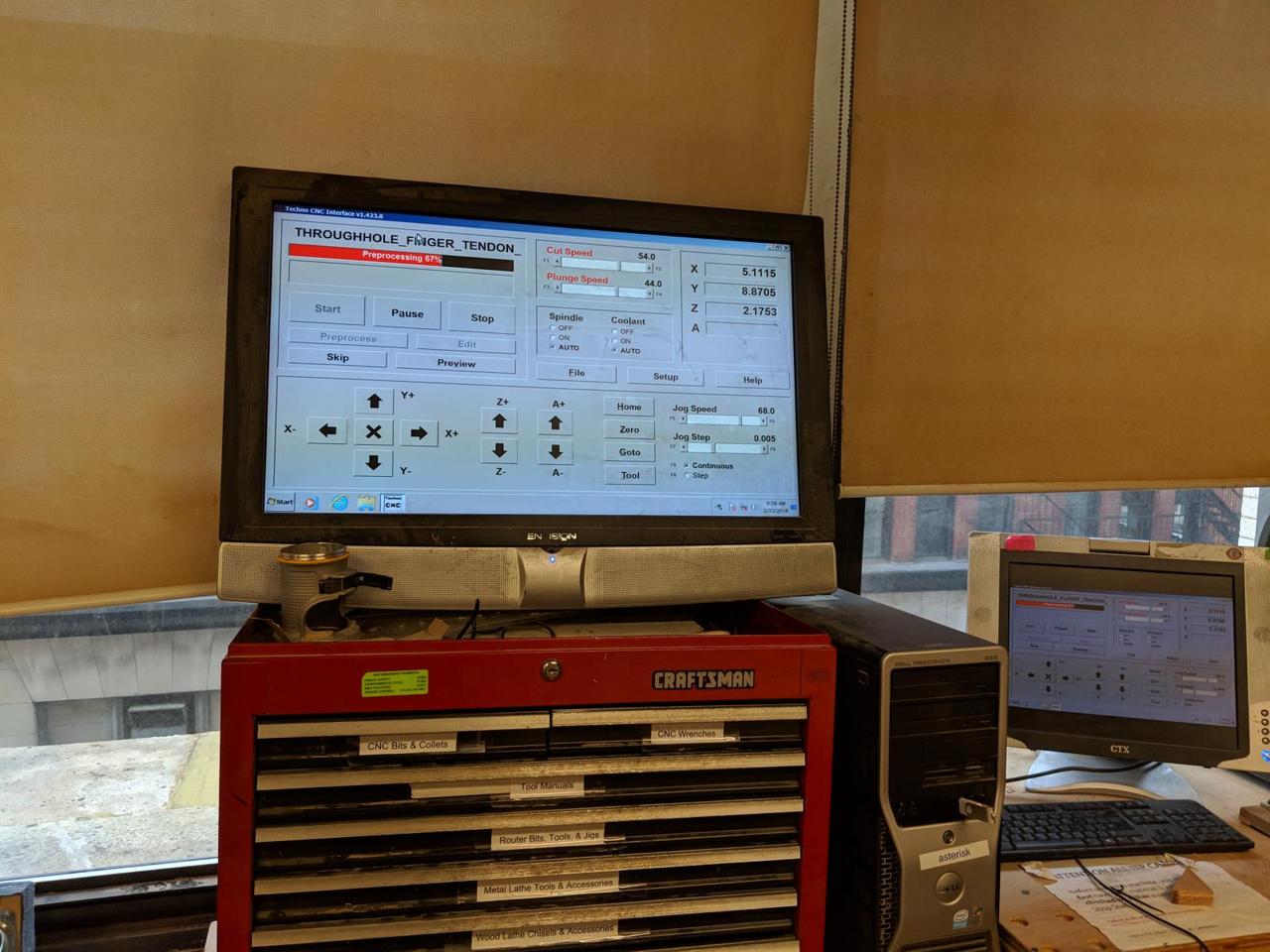 CNC computer screen with job loaded and buttons to stop or start the job.