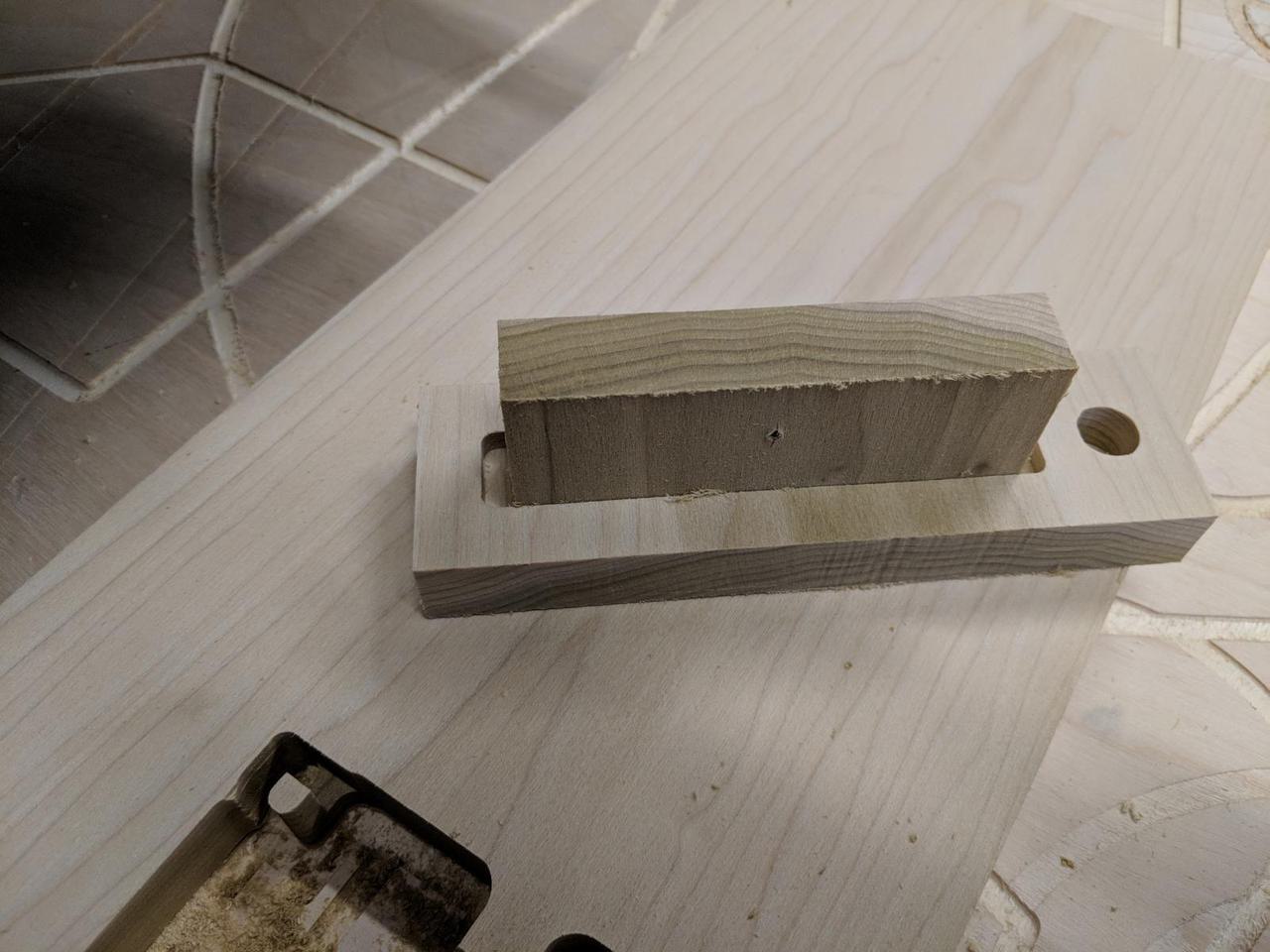 Two pieces of 0.5 inch wood joined together. The protrusions of one fit into the hole of the other, but since this is the top view, you can't tell.