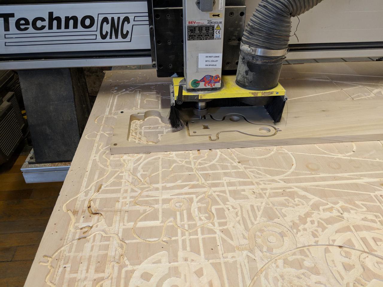 CNC bit cutting into piece of wood