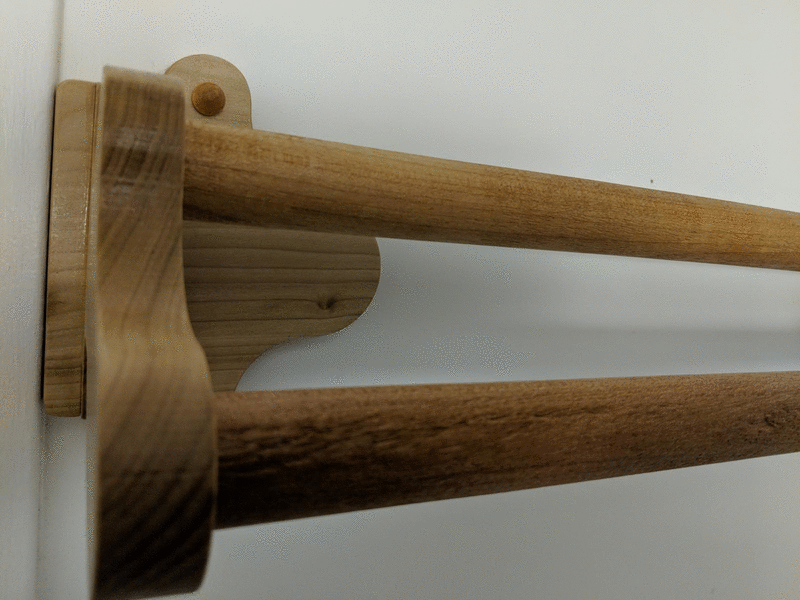 two images showing the right and left sides of the towel rack, with wooden screw covers hiding the screws attaching the towel rack onto the wall.