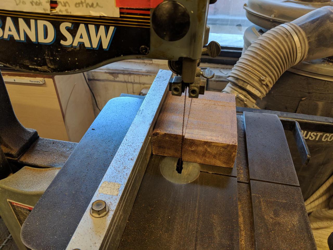 rectangular lacewood block after being cut in half on a band saw.