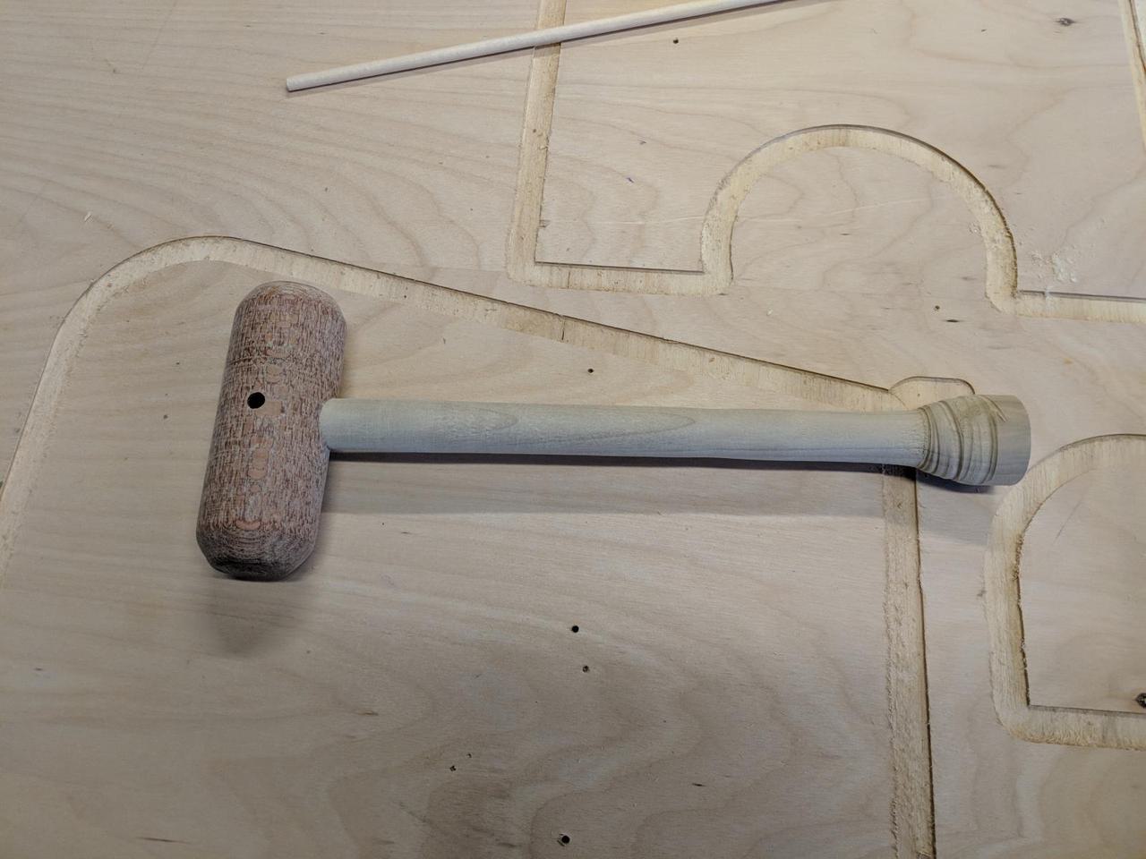 wooden handle attached to mallet head.