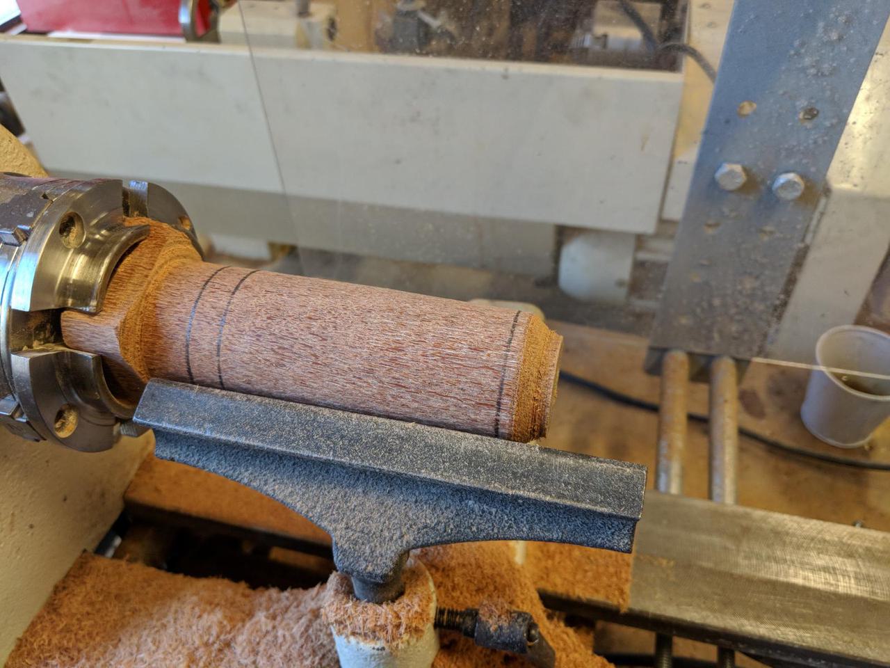 wood mounted in wood lathe but being held in place from only one end.