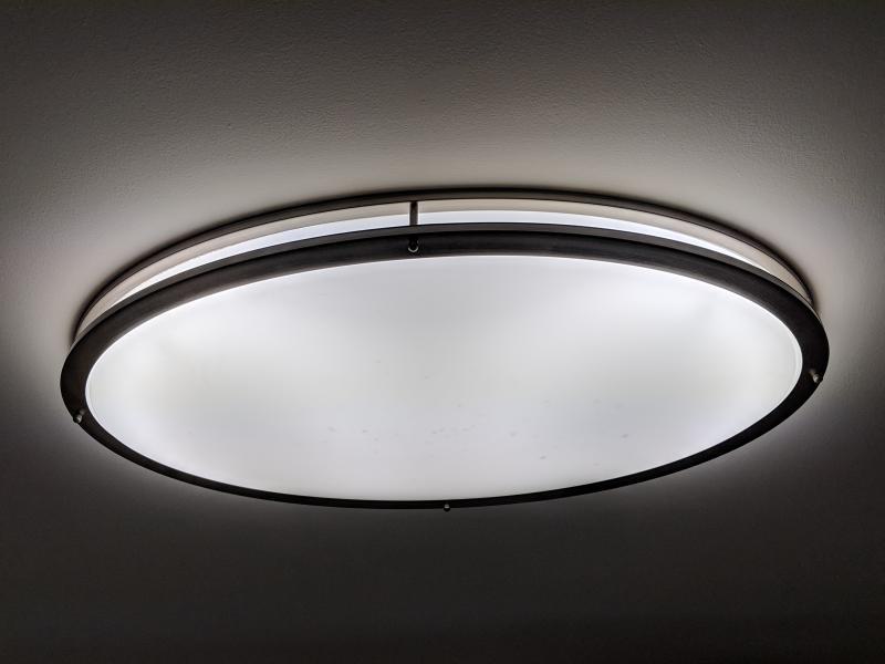 Large ceiling light shining a bright light onto the ceiling