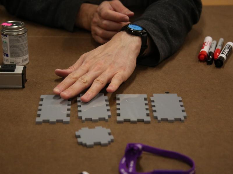 Box assembly, with the acrylic pieces laid out on the table in front of my hand.