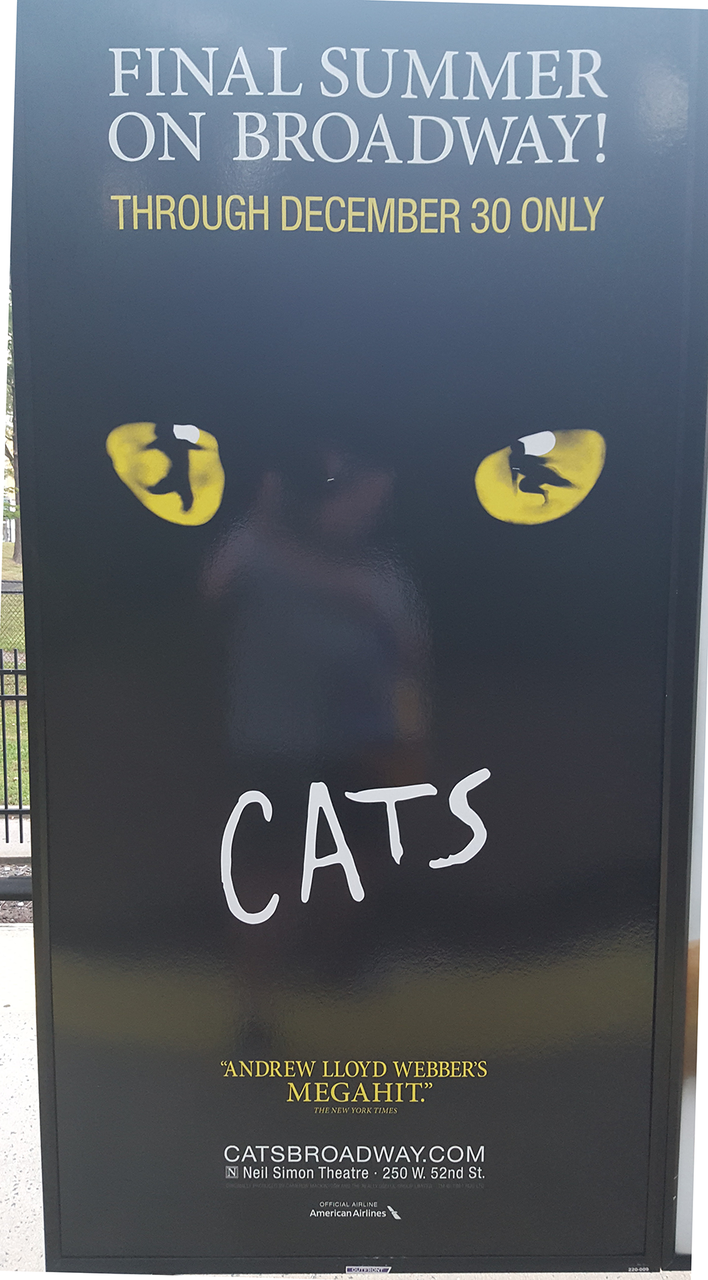 Cats musical, final summer on broadway. Two yellow cat eyes are in the center.