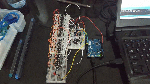LED lighting up as I push one of 16 buttons connected to two shift registers, which are connected to an Arduino.