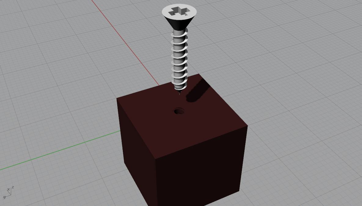 screw hovering above square block with screw hole in block