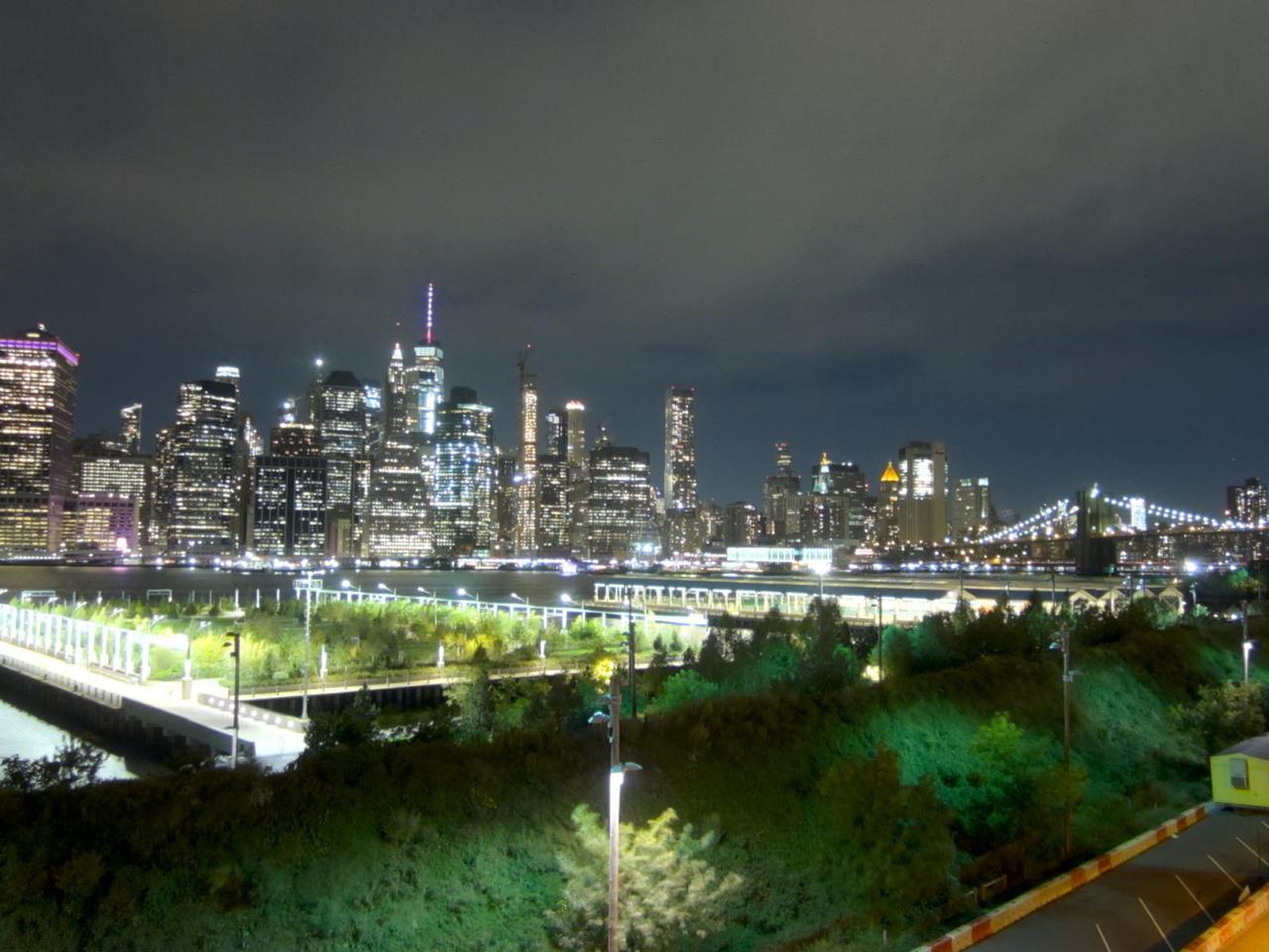view of midtown manhattan at night from brooklyn
