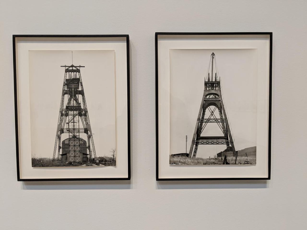 Two side-by-side photographs of two similar metal framed structures, several stories high.
