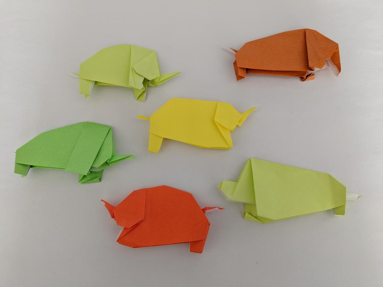 collection of origami shapes that all look elephant like, with slightly different ears or legs in each case.