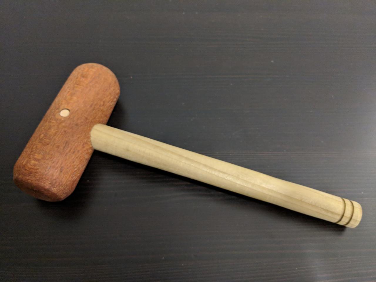 wood mallet with thin ten inch handle and fat four inch head.