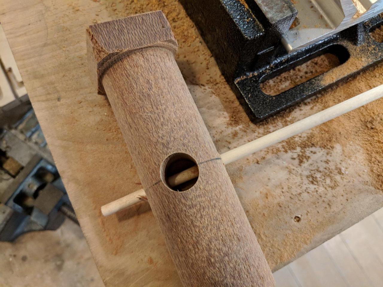 dowel rod passing through the center of the lacewood